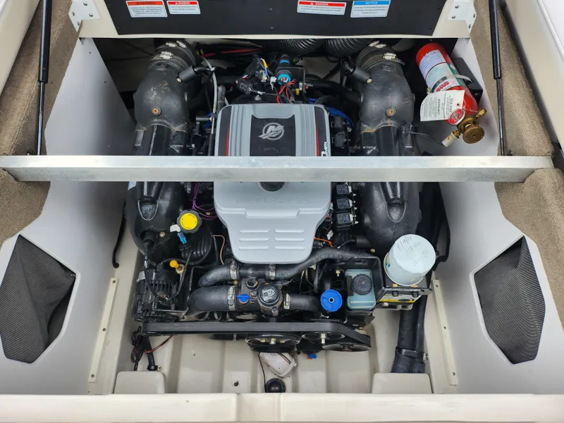 Slide: The Image of 2010 Sea Ray 210 Select engine compartment with visible components and fire extinguisher. - 24