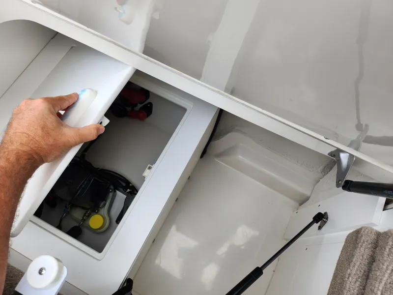 Slide: The Image of 2010 Sea Ray 210 Select storage compartment with hand opening hatch. - 25