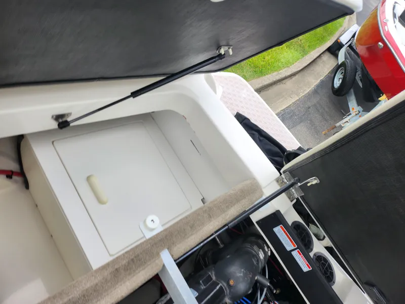 Slide: The Image of 2010 Sea Ray 210 Select boat interior with open storage compartments. - 26