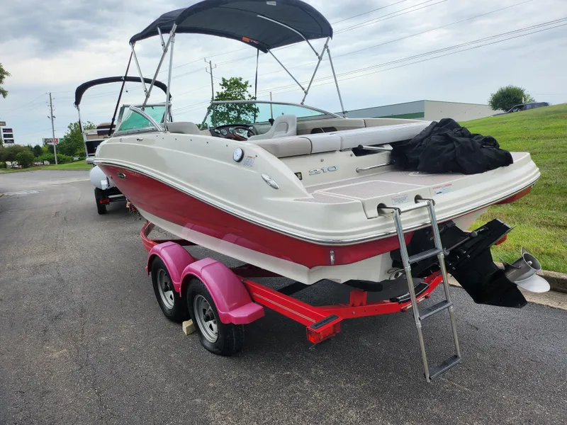 Slide: The Image of 2010 Sea Ray 210 Select boat on trailer, red and white, with canopy. - 3