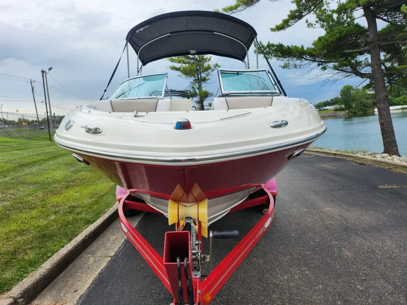 Slide: The Image of 2010 Sea Ray 210 Select boat on trailer by lakeside road. - 6