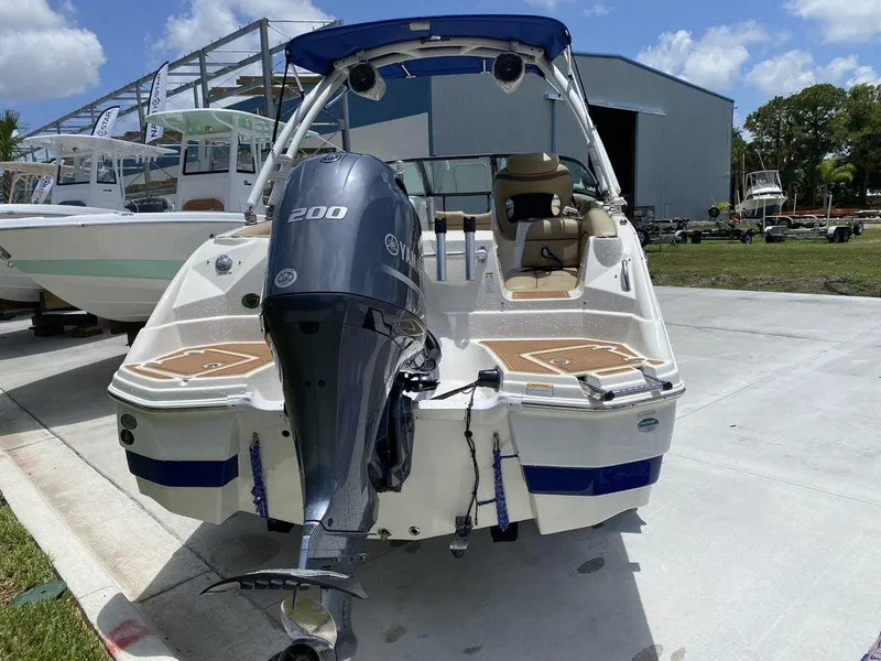 Slide: The Image of 2019 NauticStar 243 DC boat with Yamaha 200 engine, docked outdoors. - 12
