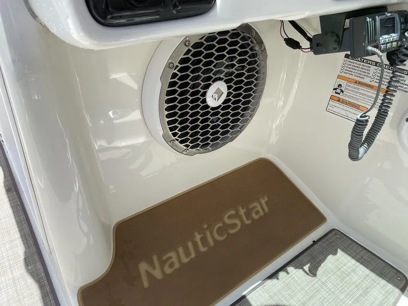 Slide: The Image of 2019 NauticStar 243 DC boat interior with speaker and control panel. - 13