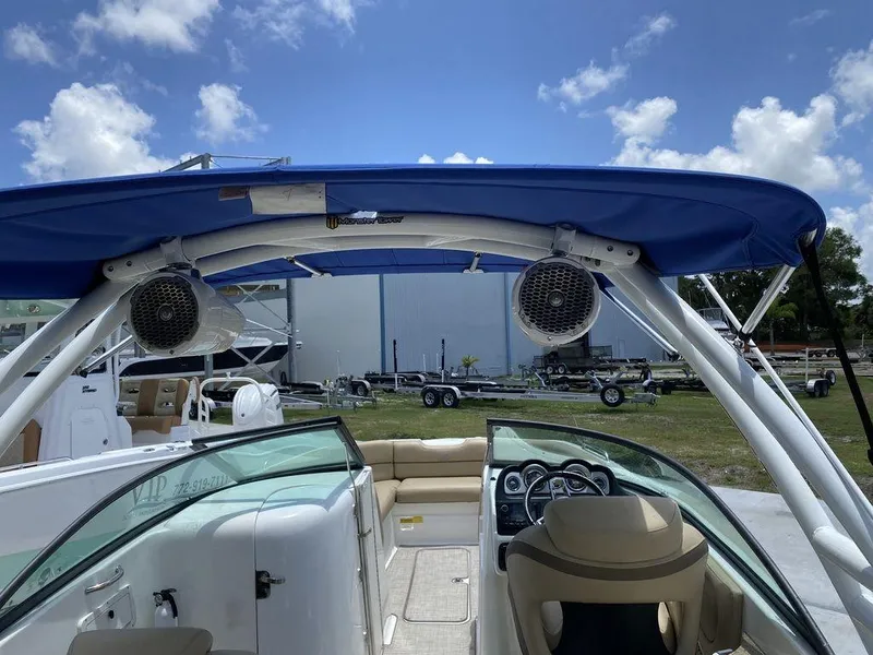 Slide: The Image of 2019 NauticStar 243 DC boat interior with blue canopy and speakers. - 6