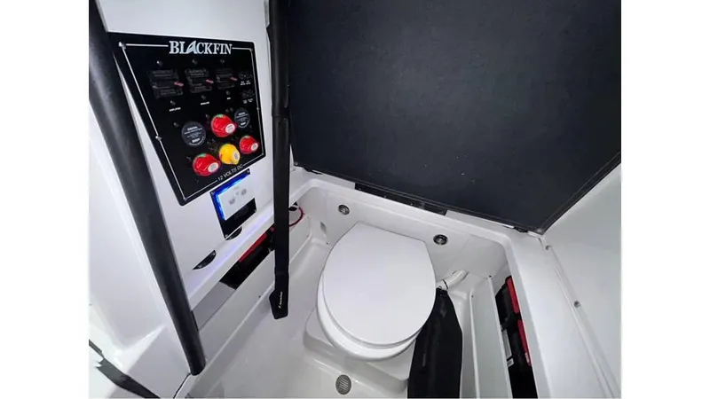 Slide: The Image of 2025 Blackfin 252 CC boat interior with control panel and toilet. - 11