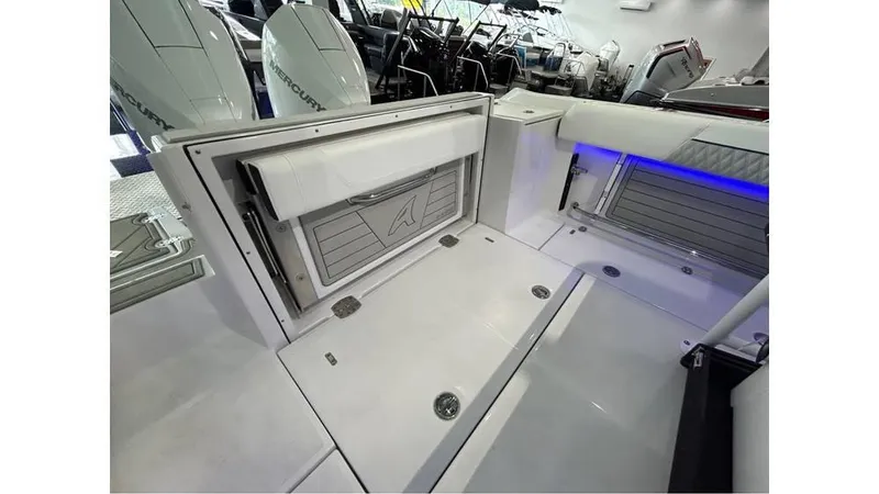 Slide: The Image of 2025 Blackfin 252 CC boat interior with storage compartments and sleek design. - 14