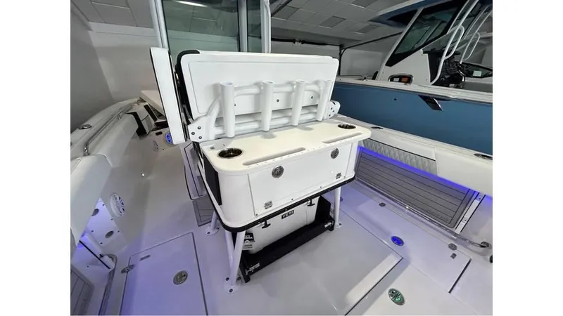 Slide: The Image of 2025 Blackfin 252 CC boat interior with rod holders and storage compartments. - 16
