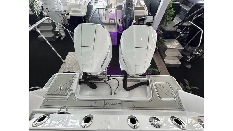 Slide: The Image of 2025 Blackfin 252 CC boat with dual outboard engines at a showroom. - 17