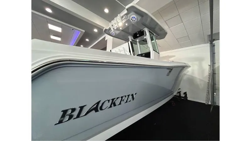 Slide: The Image of 2025 Blackfin 252 CC boat displayed indoors, showcasing sleek design and modern features. - 3