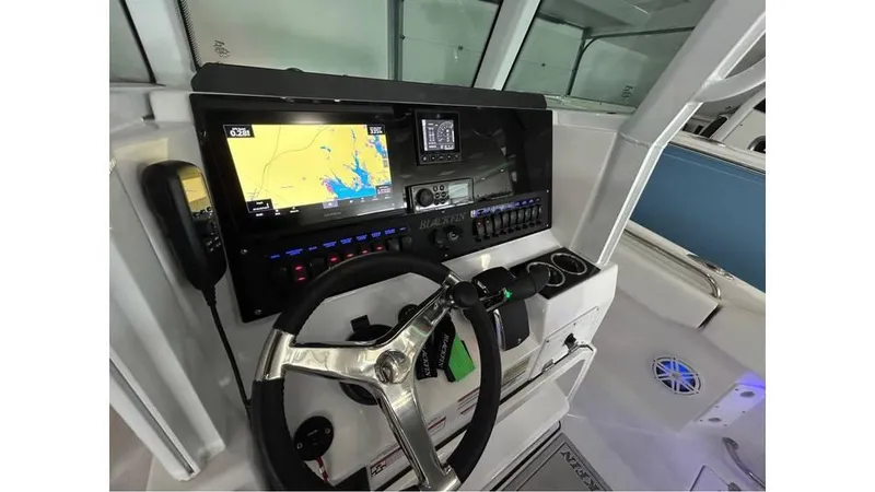 Slide: The Image of 2025 Blackfin 252 CC boat dashboard with navigation system and steering wheel. - 6