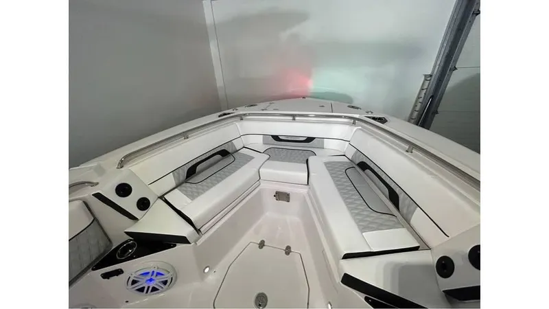 Slide: The Image of 2025 Blackfin 252 CC boat interior with cushioned seating and modern design. - 9