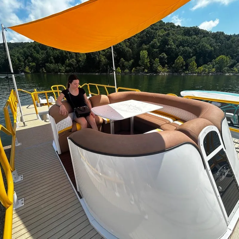 Slide: The Image of 2025 Aloha Pontoon 40' Sky View with seating area and canopy on a scenic lake. - 17