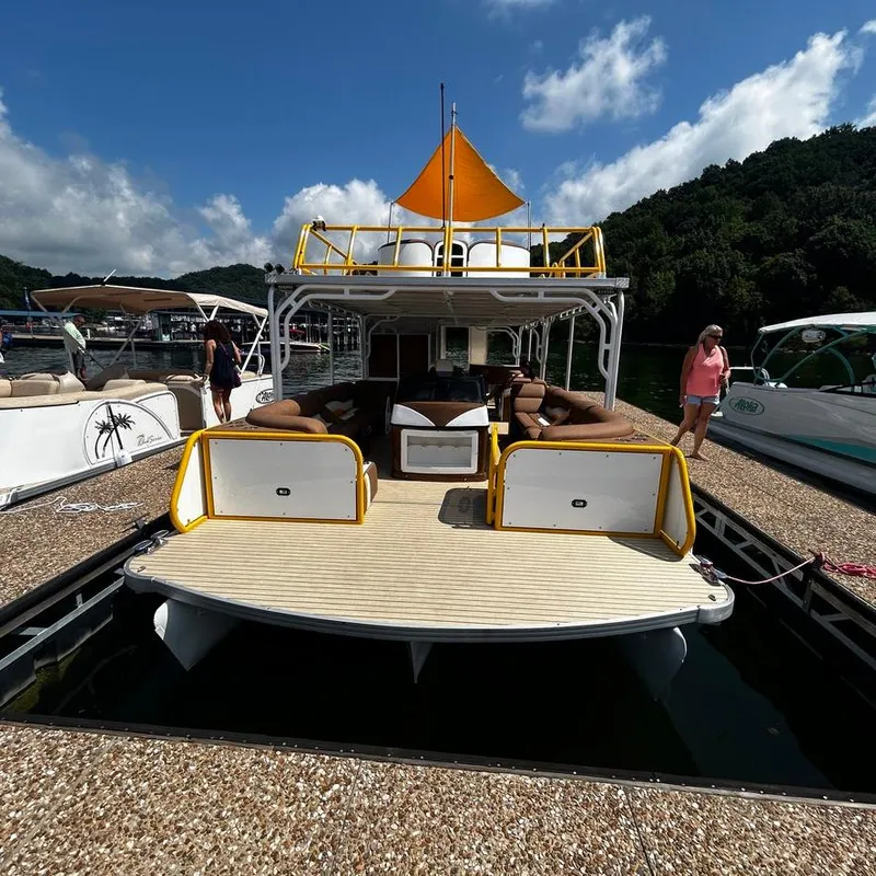 Slide: The Image of 2025 Aloha Pontoon 40' Sky View boat docked with seating area and canopy. - 19