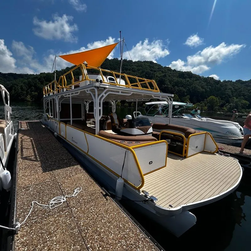 Slide: The Image of 2025 Aloha Pontoon 40' Sky View docked on a sunny day. - 4