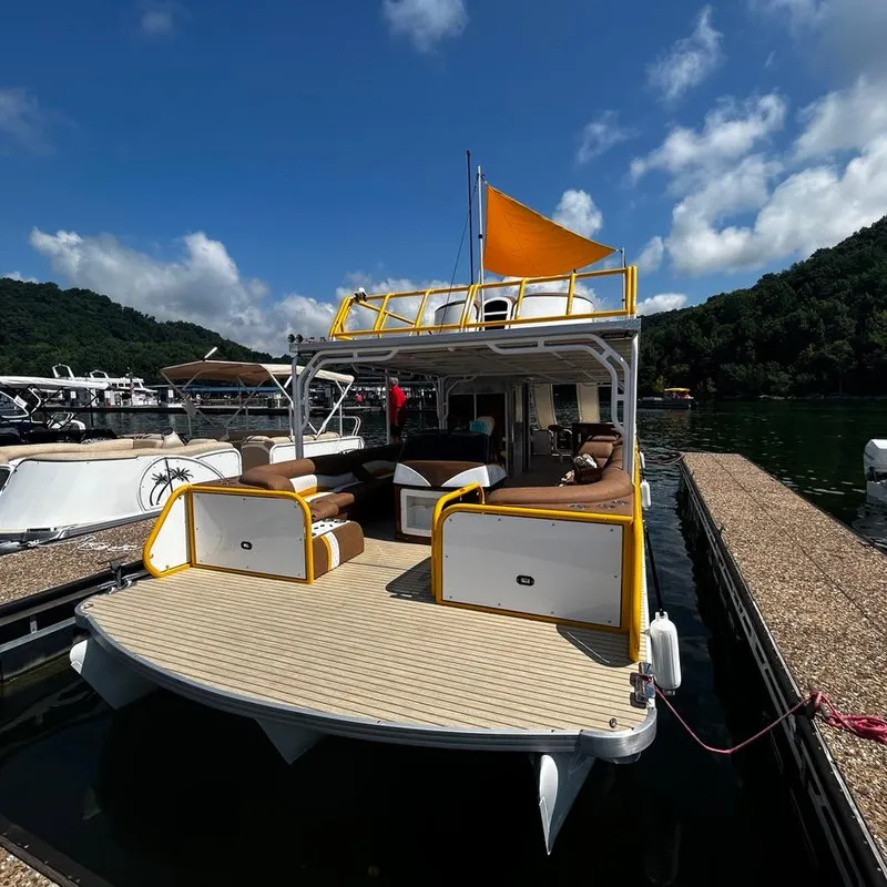 Slide: The Image of 2025 Aloha Pontoon 40' Sky View docked on a sunny day. - 5