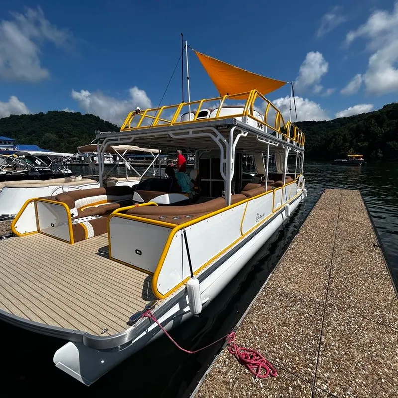 Slide: The Image of 2025 Aloha Pontoon 40' Sky View docked on a sunny day. - 6
