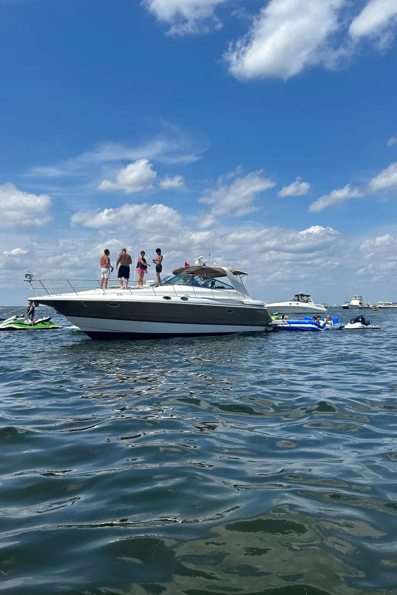 The Image of 2001 Cruisers Yachts 3870 Express on water with people enjoying sunny day. - 0