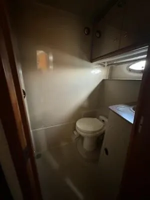 Slide: The Image of 2001 Cruisers Yachts 3870 Express bathroom interior with toilet and sink. - 14