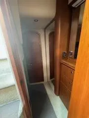 Slide: The Image of Interior hallway of 2001 Cruisers Yachts 3870 Express with wooden cabinetry. - 10