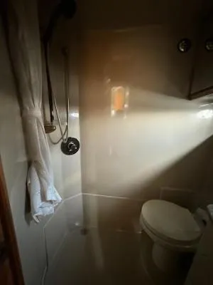Slide: The Image of Bathroom interior of 2001 Cruisers Yachts 3870 Express, featuring shower and toilet. - 16