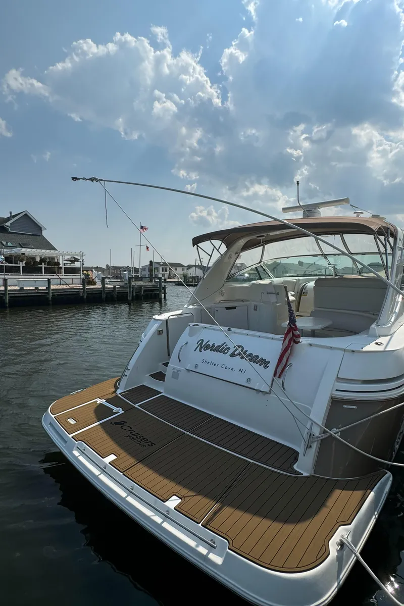 Slide: The Image of 2001 Cruisers Yachts 3870 Express docked under a partly cloudy sky. - 2
