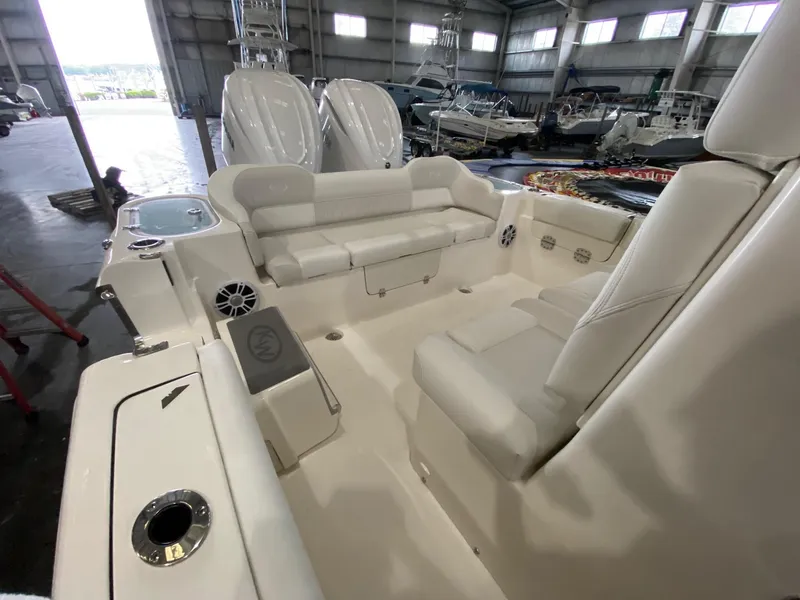 Slide: The Image of 2025 Key West 291FS boat interior with white seating in a showroom. - 10