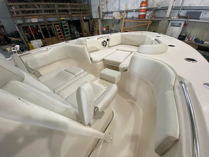 Slide: The Image of 2025 Key West 291FS boat interior with white seating in a workshop. - 12