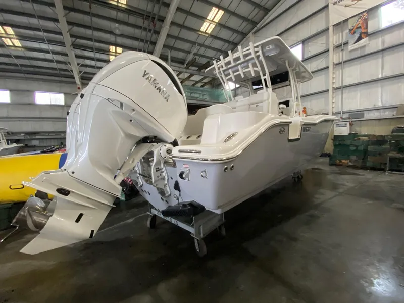 Slide: The Image of 2025 Key West 291FS boat with Yamaha engine in a warehouse. - 3