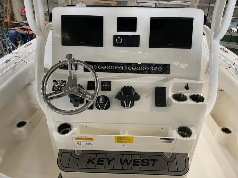 Slide: The Image of 2025 Key West 291FS boat dashboard with steering wheel and electronic displays. - 5