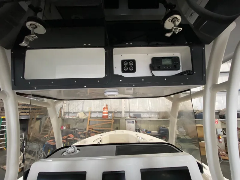 Slide: The Image of 2025 Key West 291FS boat dashboard with electronics and storage compartments. - 6