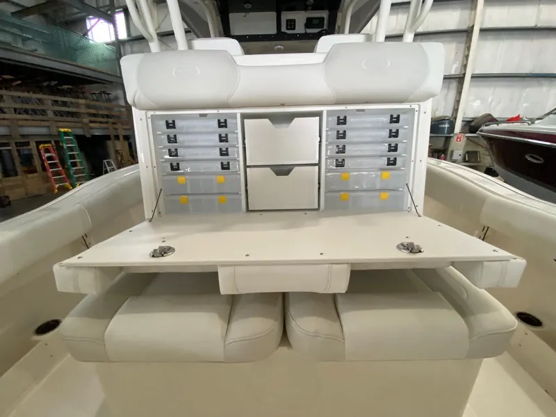 Slide: The Image of 2025 Key West 291FS boat interior with storage compartments and seating. - 9