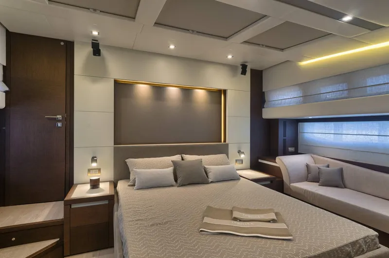 Slide: The Image of Luxurious bedroom interior on a 2016 Prestige 750 yacht, featuring modern design and ambient lighting. - 23