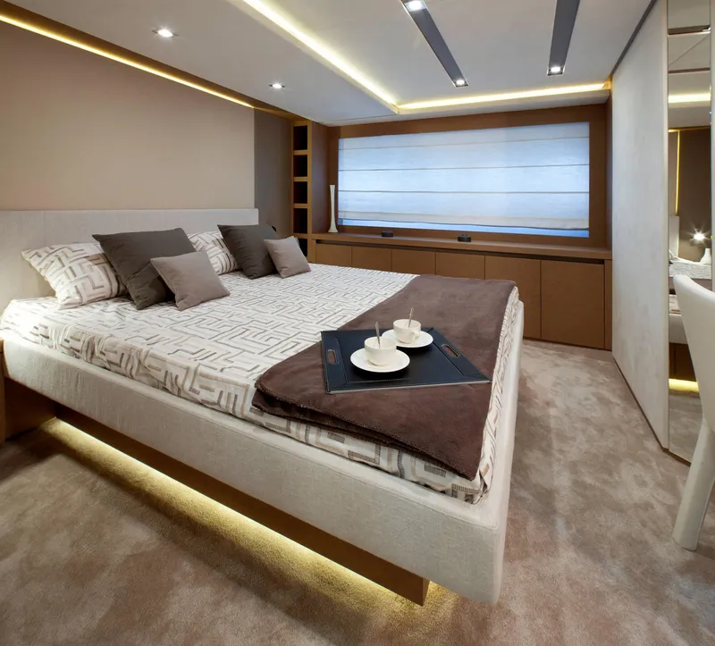 Slide: The Image of Luxurious bedroom interior on 2016 Prestige 750 yacht, featuring modern design and elegant decor. - 26