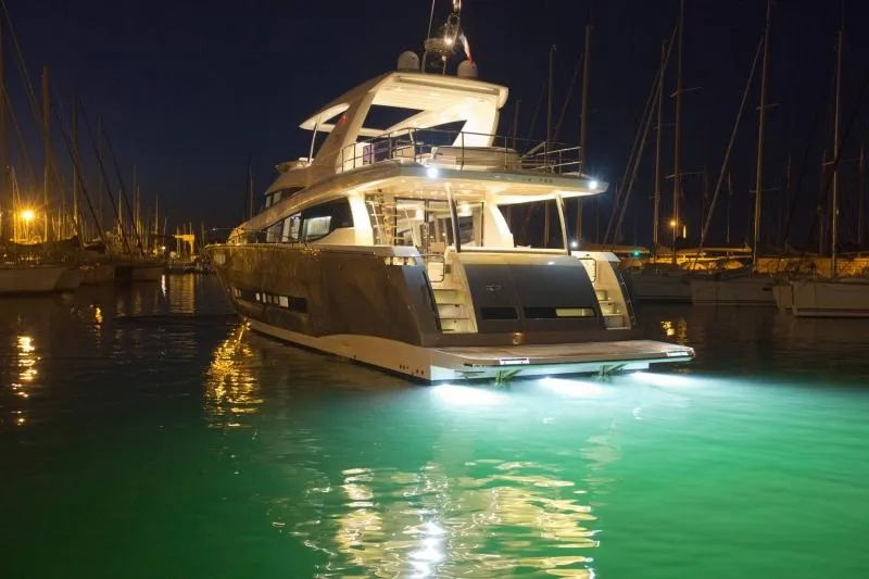 Slide: The Image of Prestige 750 yacht, 2016 model, illuminated at night in a marina. - 7