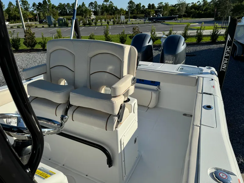 Slide: The Image of 2020 Sea Hunt Gamefish 25 boat interior with dual seats and twin engines. - 11