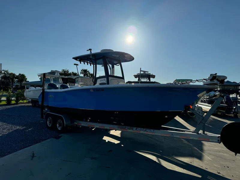 Slide: The Image of 2020 Sea Hunt Gamefish 25 boat on trailer under bright sun. - 7