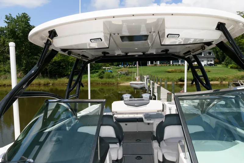 Slide: The Image of 2020 Robalo R317 Dual Console boat docked, featuring spacious seating and sleek design. - 15