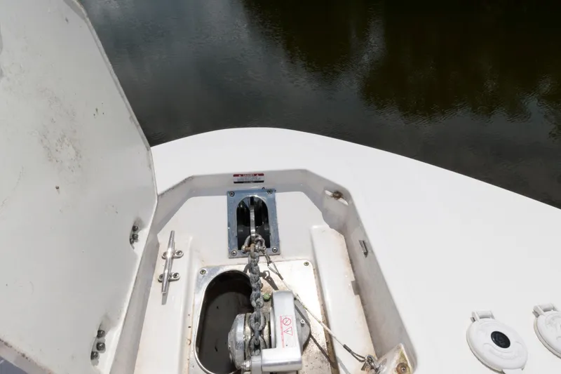 Slide: The Image of 2020 Robalo R317 Dual Console anchor compartment with open hatch. - 18