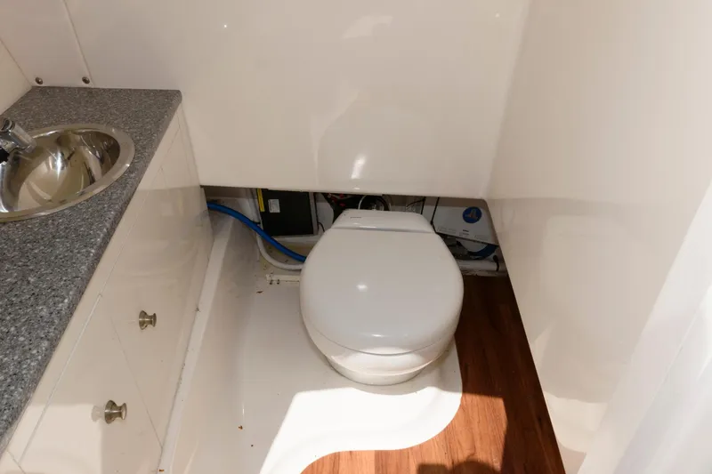 Slide: The Image of 2020 Robalo R317 Dual Console boat bathroom with sink and toilet. - 19