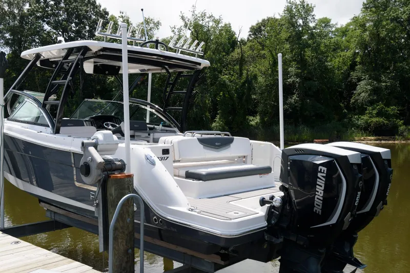Slide: The Image of 2020 Robalo R317 Dual Console boat docked with Evinrude engines. - 2