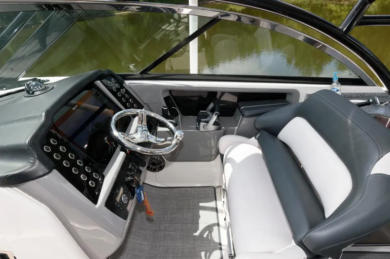 Slide: The Image of 2020 Robalo R317 Dual Console boat interior with steering wheel and seating. - 5