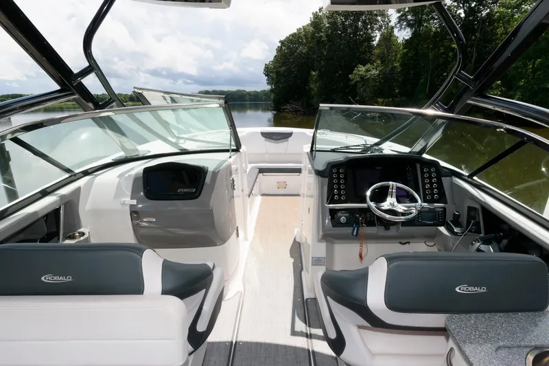 Slide: The Image of 2020 Robalo R317 Dual Console boat interior with modern dashboard and seating. - 9
