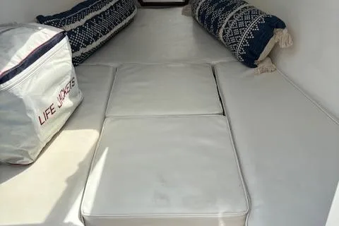 Slide: The Image of 2004 Marlago FS35 boat interior with cushions, pillows, and life jackets. - 13