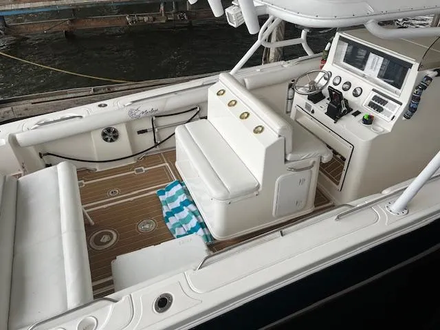 Slide: The Image of 2004 Marlago FS35 boat interior with white seating and control panel. - 7