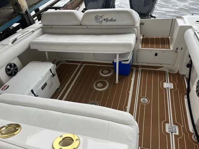 Slide: The Image of 2004 Marlago FS35 boat interior with cushioned seating and wooden deck. - 8