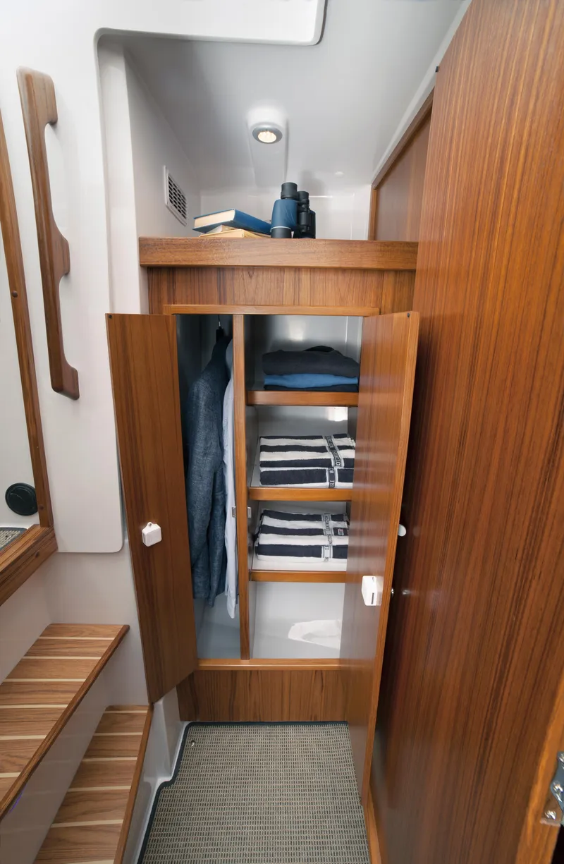 Slide: The Image of 2024 Sargo 31 boat interior with wooden cabinetry and neatly organized shelves. - 11