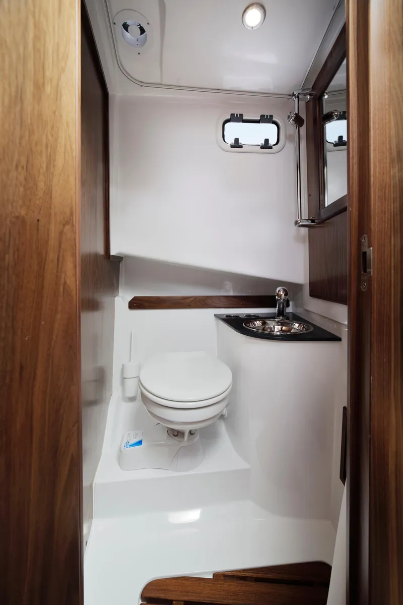 Slide: The Image of 2024 Sargo 31 boat bathroom with modern fixtures and wooden accents. - 14