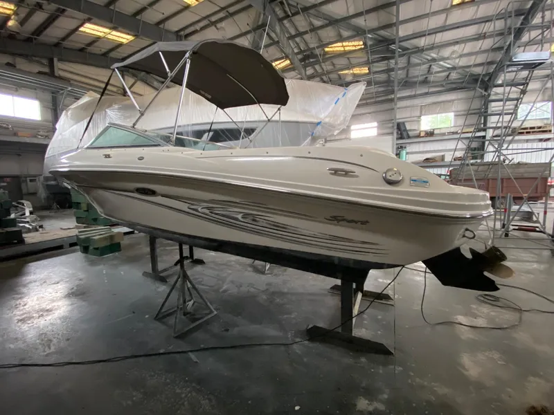 Slide: The Image of 2005 Sea Ray 200 Sport boat in a warehouse on a stand. - 0