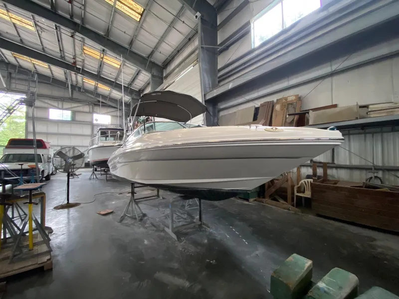 Slide: The Image of 2005 Sea Ray 200 Sport boat in a spacious indoor storage facility. - 3