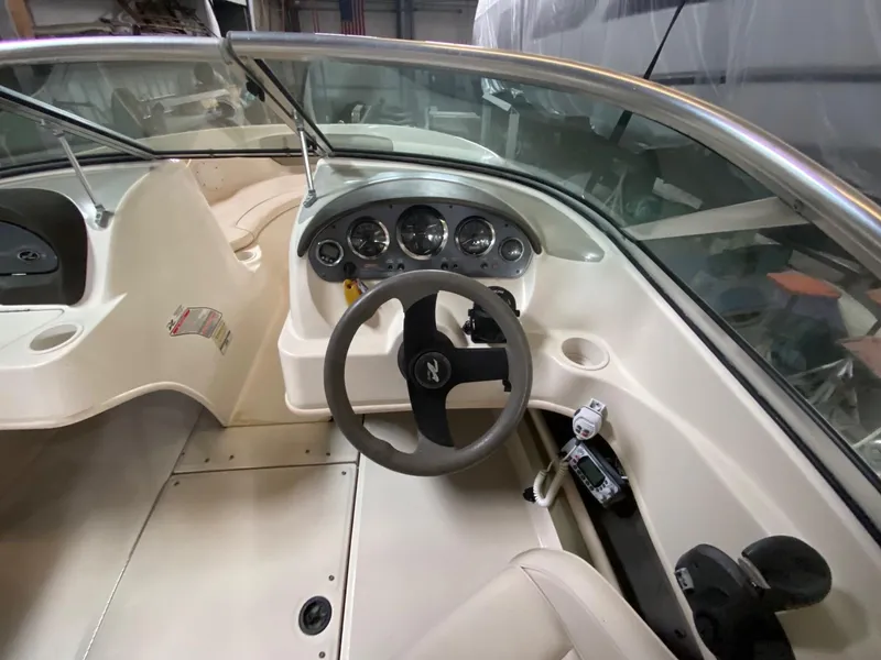 Slide: The Image of 2005 Sea Ray 200 Sport boat interior with steering wheel and dashboard controls. - 5